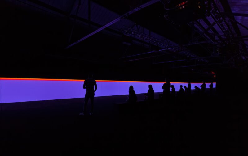 Carsten Nicolai – unicolor, 2014, DLP-projectors, DMX-LED lights, projection screen, mirrors, computer, sound, bench with loudspeakers.