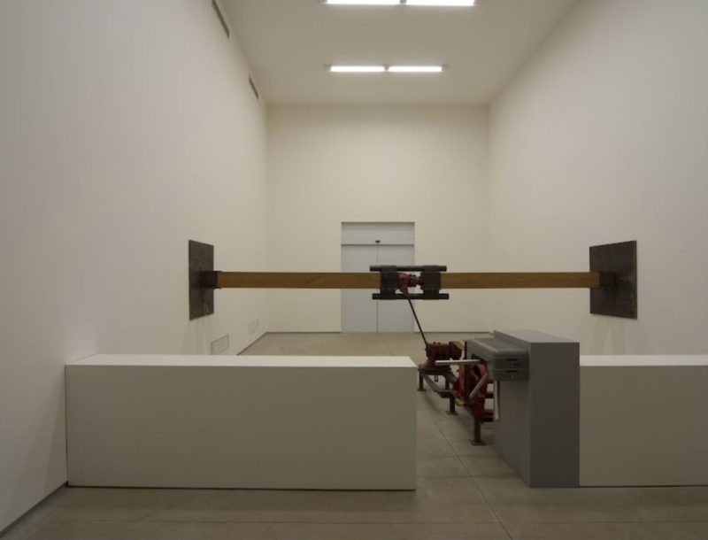 Chris Burden - Samson, 1985, turnstile, winch, worm gear, leather strap, jack, timbers, steel, steel plates, dimensions variable, installation view, Inhotim Museum, Brazil