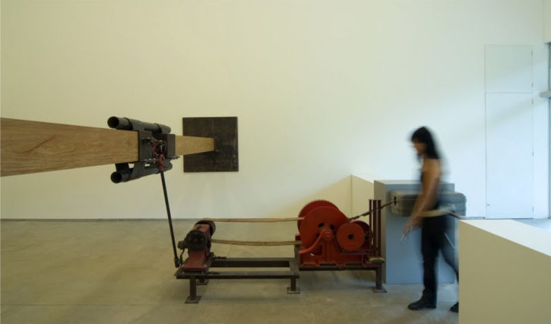 Chris Burden - Samson, 1985, turnstile, winch, worm gear, leather strap, jack, timbers, steel, steel plates, dimensions variable, installation view, Inhotim Museum, Brazil