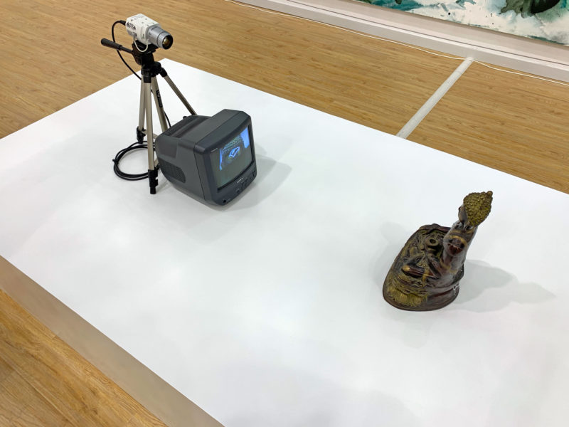 Nam June Paik - TV Buddha, 2002, Bronze, paint, television monitor, closed-circuit video camera, tripod, transformer, adaptors, television:video cable and extension cords