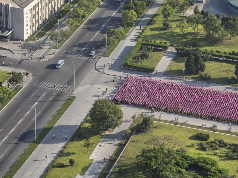 Carl De Keyzer - Tower of the Juche Idea. Pyongyang. Pyongyang citizens practice for a mass rally beneath the Tower of the Juche Idea. Such rallies can involve tens of thousands of people, and take significant time and energy to plan, practice, and coordinate. 16 September 2015 4:00 PM
