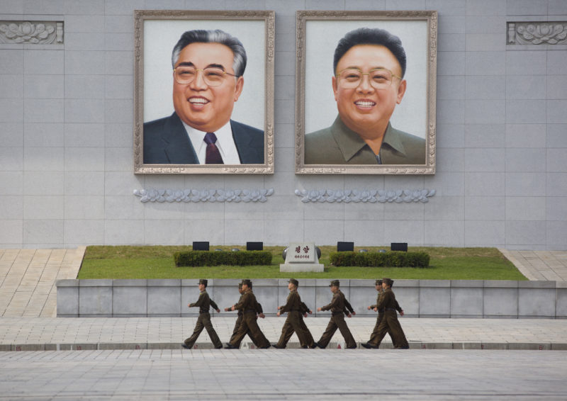 Eric Lafforgue – North Korea - North Korean army soldiers pass in front of the giant portraits of Kim Jong-il and Kim Il-Sung at Kim Il-sung Square in Pyongyang