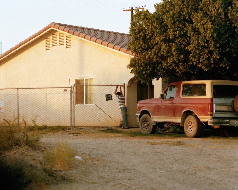 Ron Jude - Lago - Boy Leaning on Fence, 2013