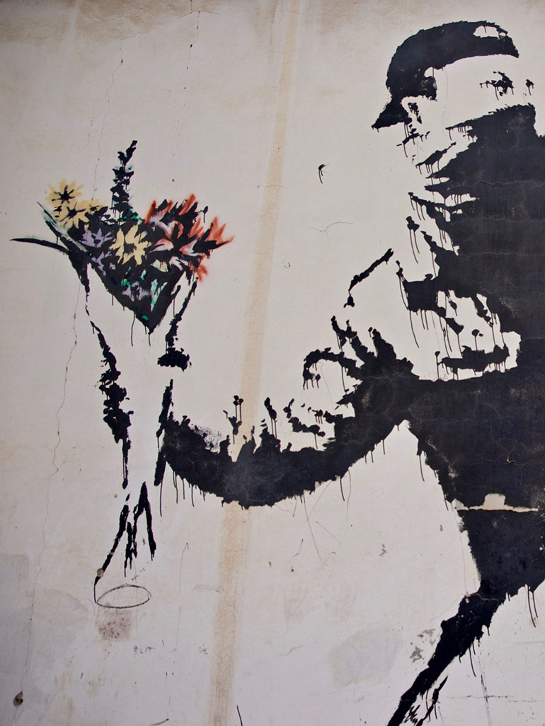 Banksy-–-Love-Is-In-The-Air-Flower-Thrower-2005-Ash-Salon-Street-Bethlehem-West-Bank-1-scaled-1