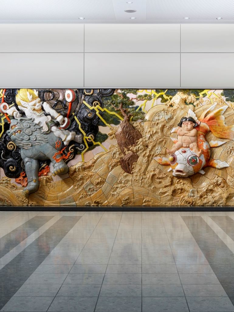 Katsuhiro Otomo - Kinka Doji Riding the Waves Accompanied by Fujin and Raijin, 2015, ceramic relief, 8.7 x 2.8 meter, installation view, Sendai Airport, Japan feat