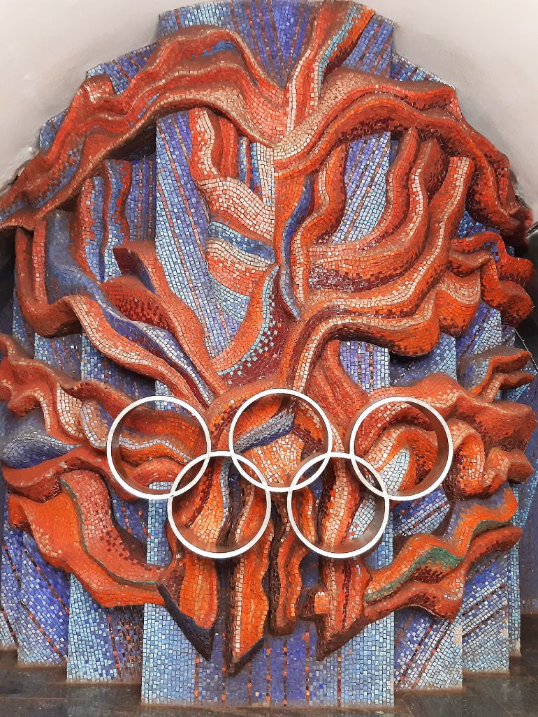 Olympic Flame mosaic at the end of the central hall in the metro station Olimpiiska, Kyiv, Ukraine feat