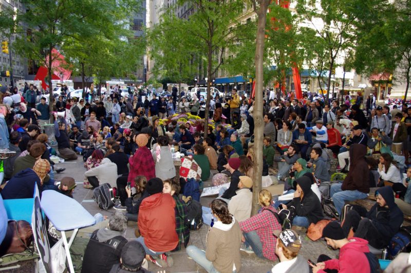 The second day of Occupy Wall Street Day, September 18, 2011, in Zuccotti Park with Noguchi's Red Cube in the background