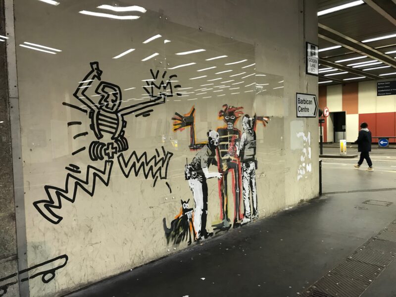 Banksy - Portrait of Basquiat being welcomed by the Metropolitan police, 2017, installation view, Barbican Center, London, England