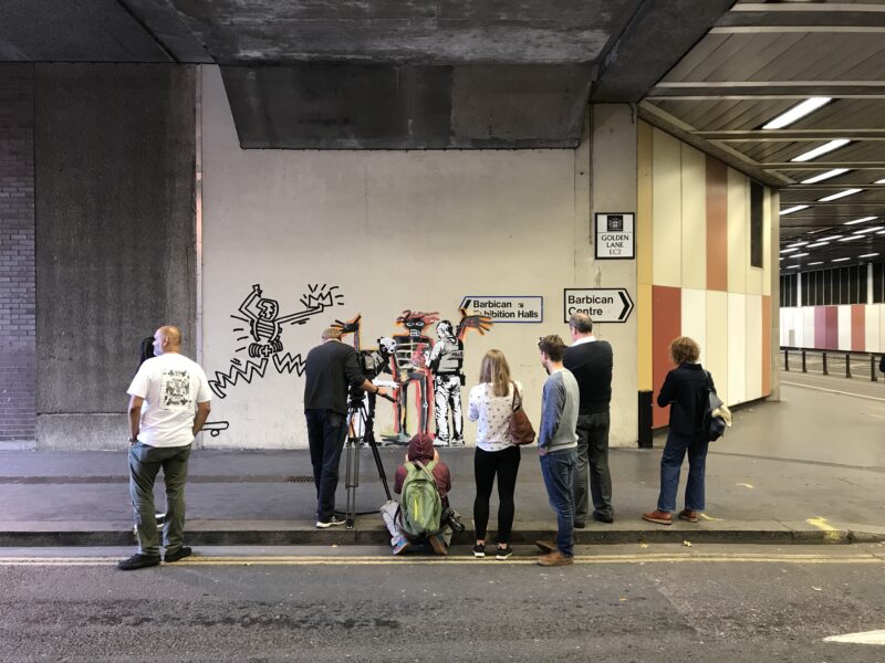 Banksy - Portrait of Basquiat being welcomed by the Metropolitan police, 2017, installation view, Barbican Center, London, England