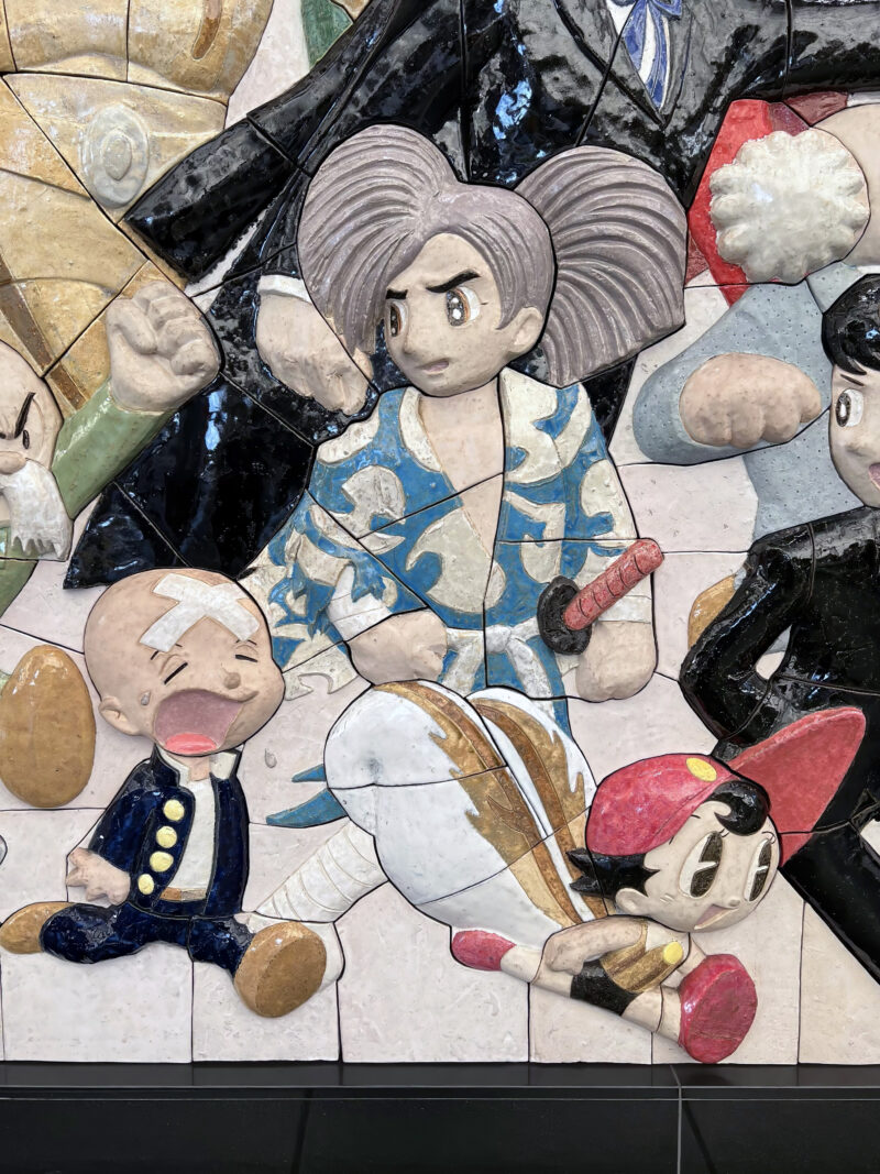 Tezuka Osamu - Characters on Parade, 2019, 460 ceramic tiles, 2.6 meters high, 8.8 meters wide, installation view, Kokusai-Tenjijō station, Kōtō, Tokyo, Japan
